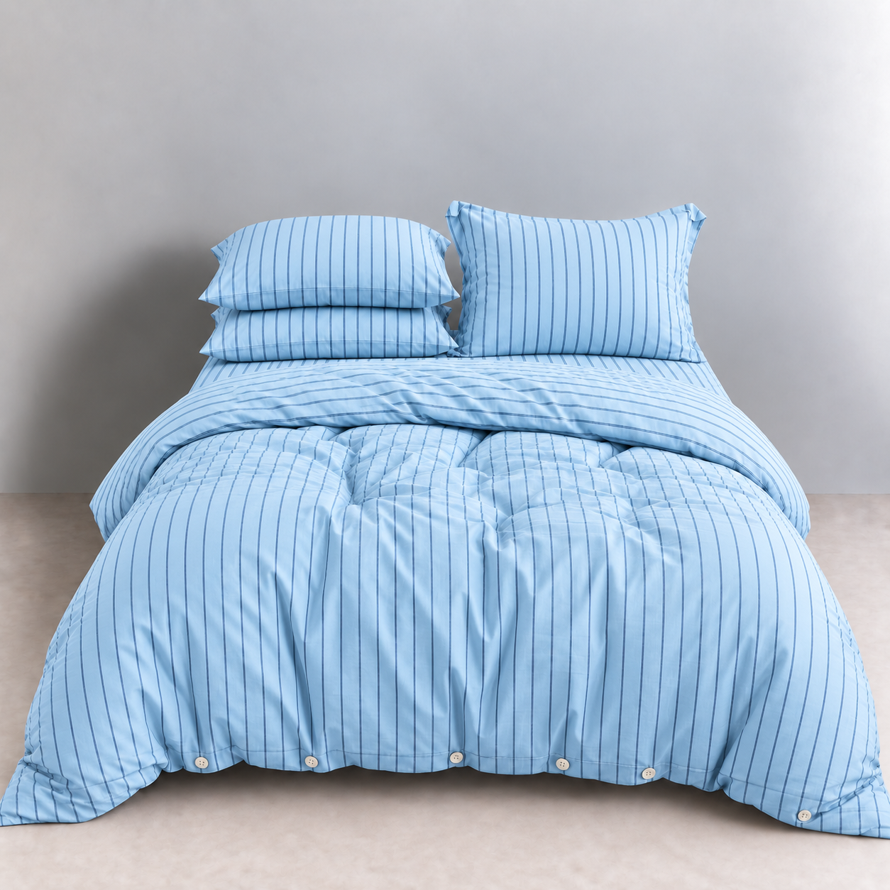 Juno Stripe Bedding Set in Baltic Blue, made bed with pinstripe cotton quilt cover and button closures