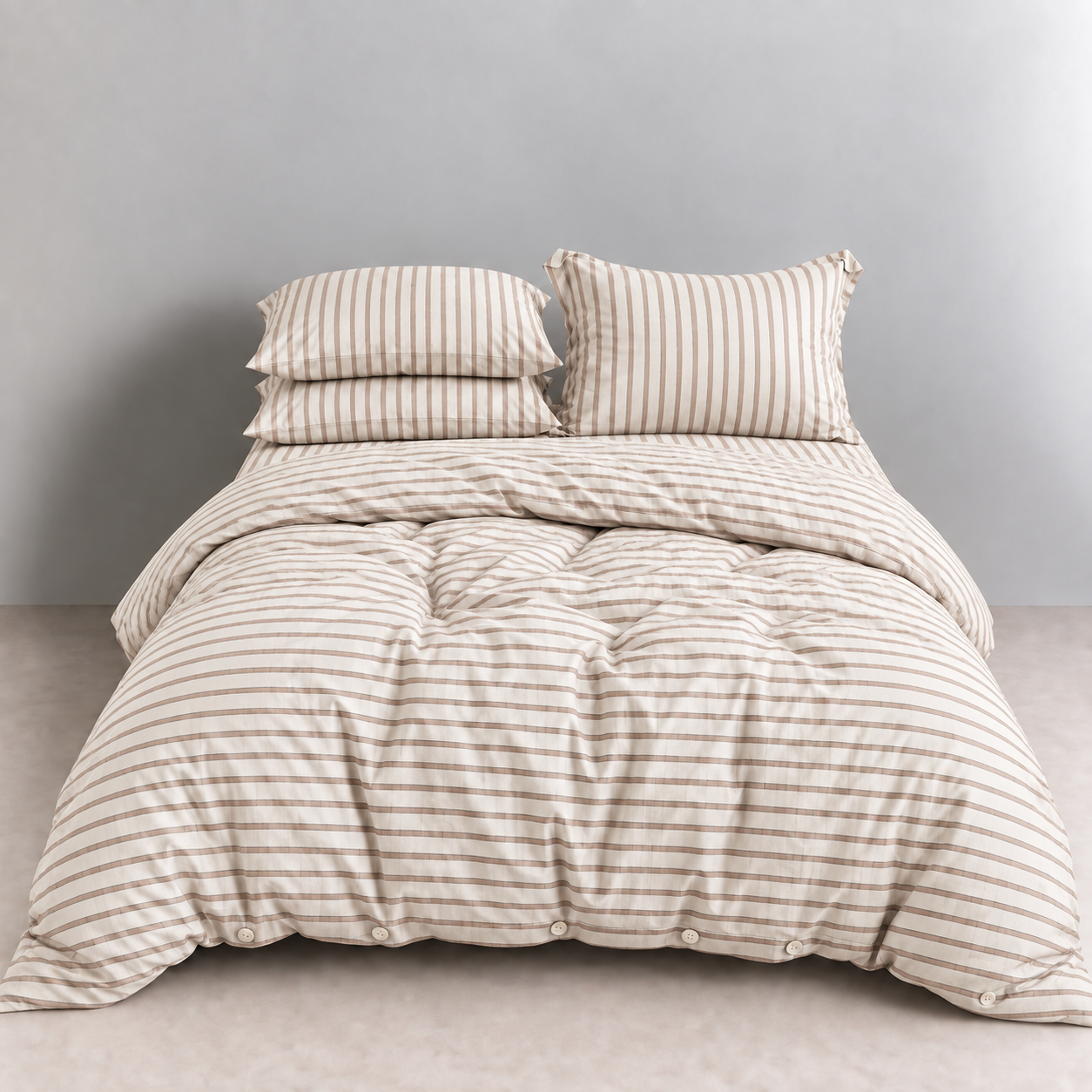 Juno Stripe Bedding Set in Biscotti, tan stripes on cream cotton, made bed with button quilt cover
