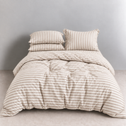 Juno Stripe Bedding Set in Biscotti, tan stripes on cream cotton, made bed with button quilt cover