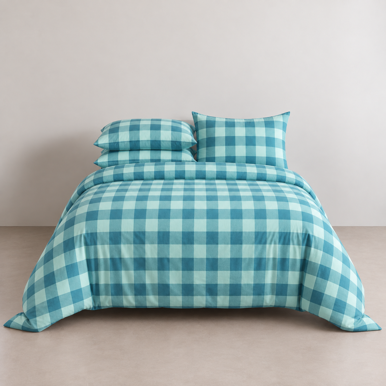 Kyoto Plaid Bedding Set in Pacific Tide, teal and mint check on a made bed against a plain wall