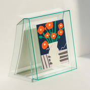 Lana Photo Frame in Aqua Blue, clear acrylic with a neon edge holding a bright floral print, angled view