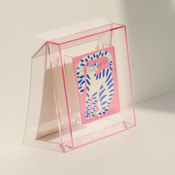 Lana Photo Frame in Baby Pink, clear acrylic with neon pink edge, angled on a tabletop