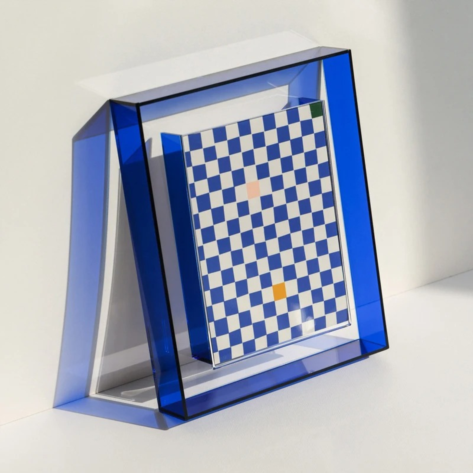 Lana Photo Frame in Royal Blue acrylic, angled to show its clear depth, holding a blue chequered print