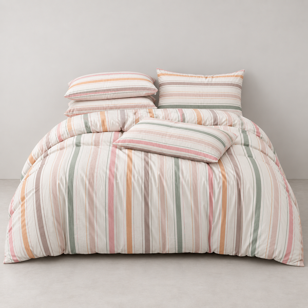Layla Striped Bedding Set on a made bed, vertical stripes in blush, terracotta and sage on white cotton
