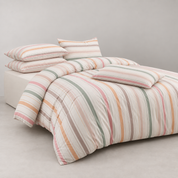Layla Striped Bedding Set on a made bed, cotton stripes in blush, sage, ochre and taupe