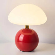 Lumi Mushroom Table Lamp in Apple Red, glossy round base with domed frosted shade lit warm