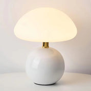 Lumi Mushroom Table Lamp in Ivory, glossy round base with brass neck and softly glowing domed shade