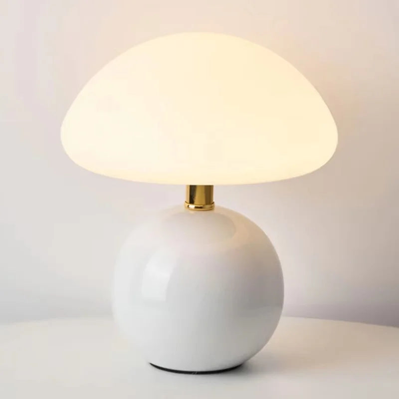 Lumi Mushroom Table Lamp in Ivory, glossy round base with brass neck and softly glowing domed shade
