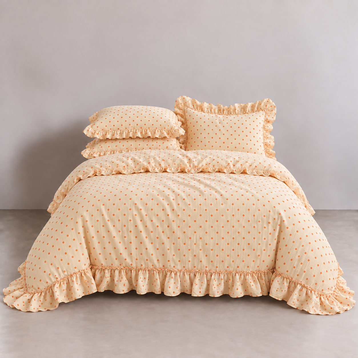 Mable Spot Bedding Set in Apricot, made bed with ruffled quilt cover and pillowcases in orange spots