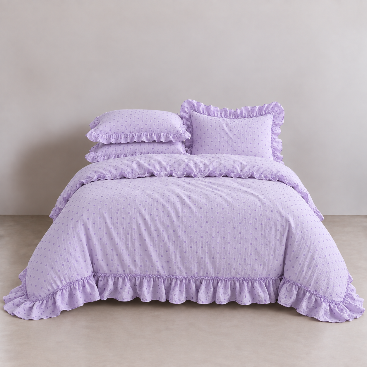 Mable Spot Bedding Set in Lavender, made bed with gathered ruffle edges and tonal spot print on twill