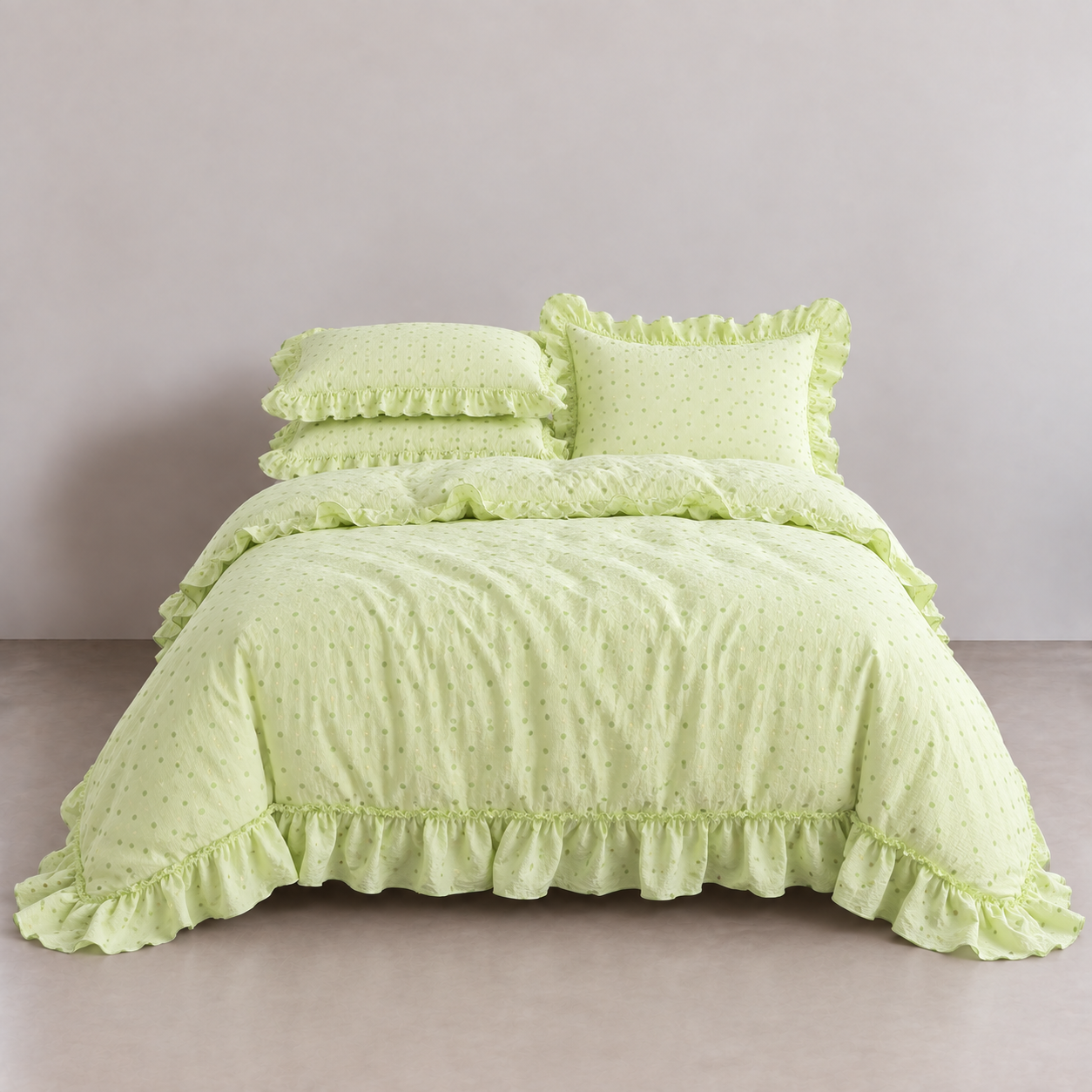 Mable Spot Bedding Set in Pistachio, ruffled quilt cover and pillowcases in light green spot twill on a made bed