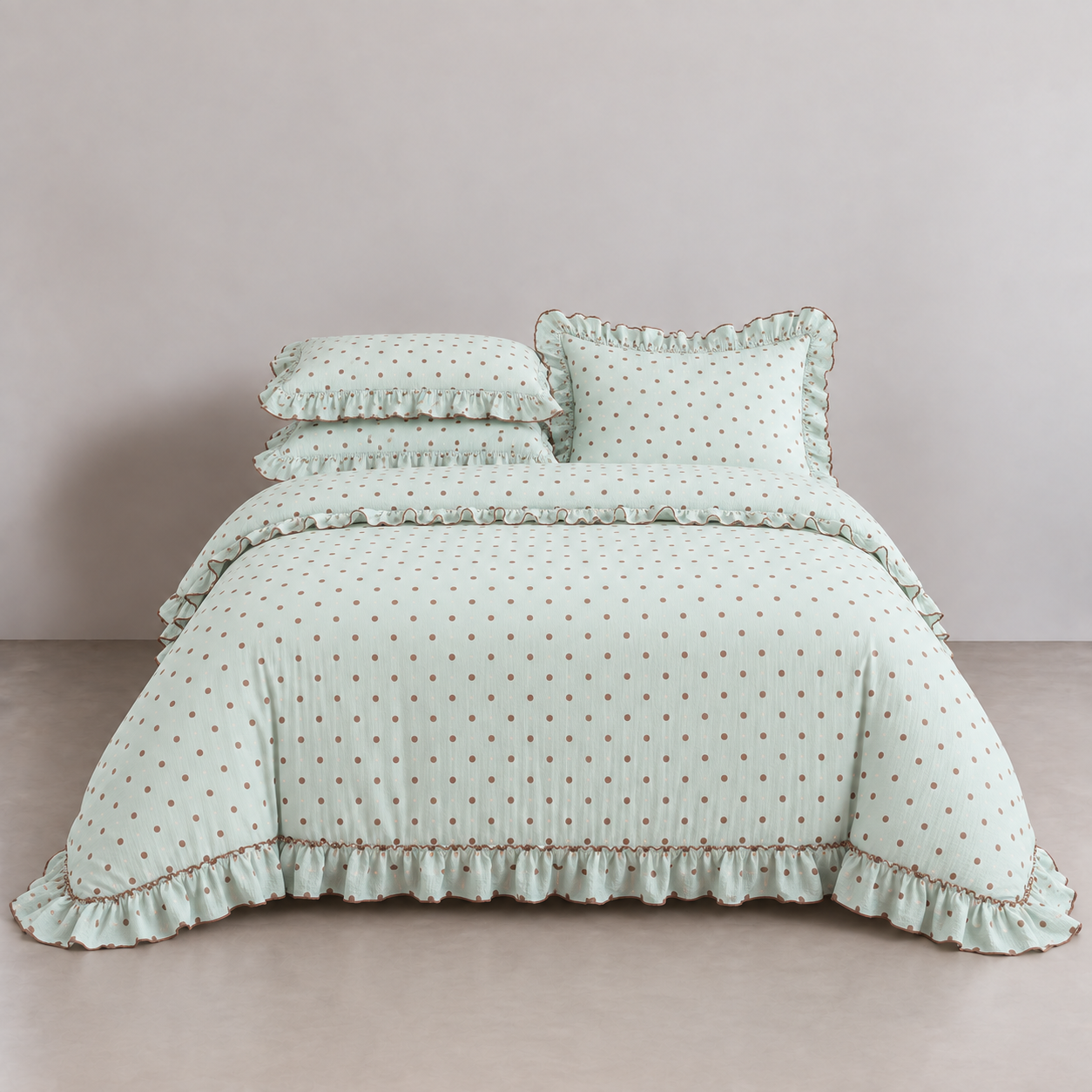 Mable Spot Bedding Set in Sage, made bed with brown spots and gathered ruffle edging on cover and pillowcases