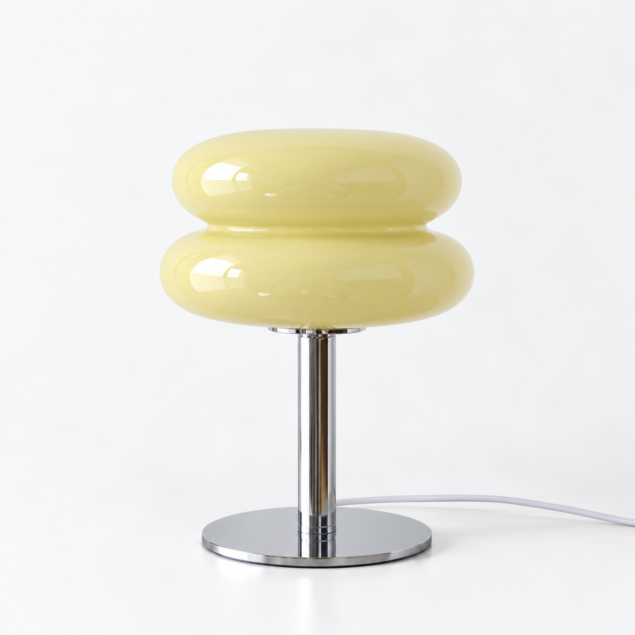 Macaron Lamp in Lemon, glossy stacked glass shade on a chrome base against a plain background