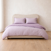 Marseille Stripe Bedding Set in Lavender Macaron, striped quilt cover and pillowcases on a made bed