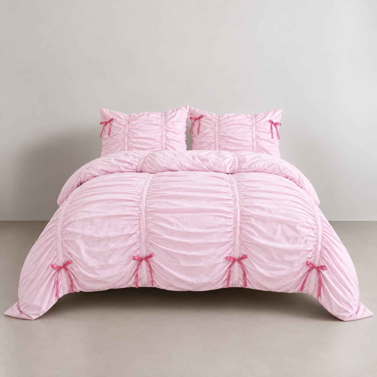 Metaya Bedding Set in Blush Pink, ruched quilt cover and pillowcases with pink ribbon bow ties on a made bed