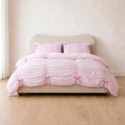 Metaya Bedding Set in Blush Pink, ruched cotton quilt cover with pink bow ties on a made bed