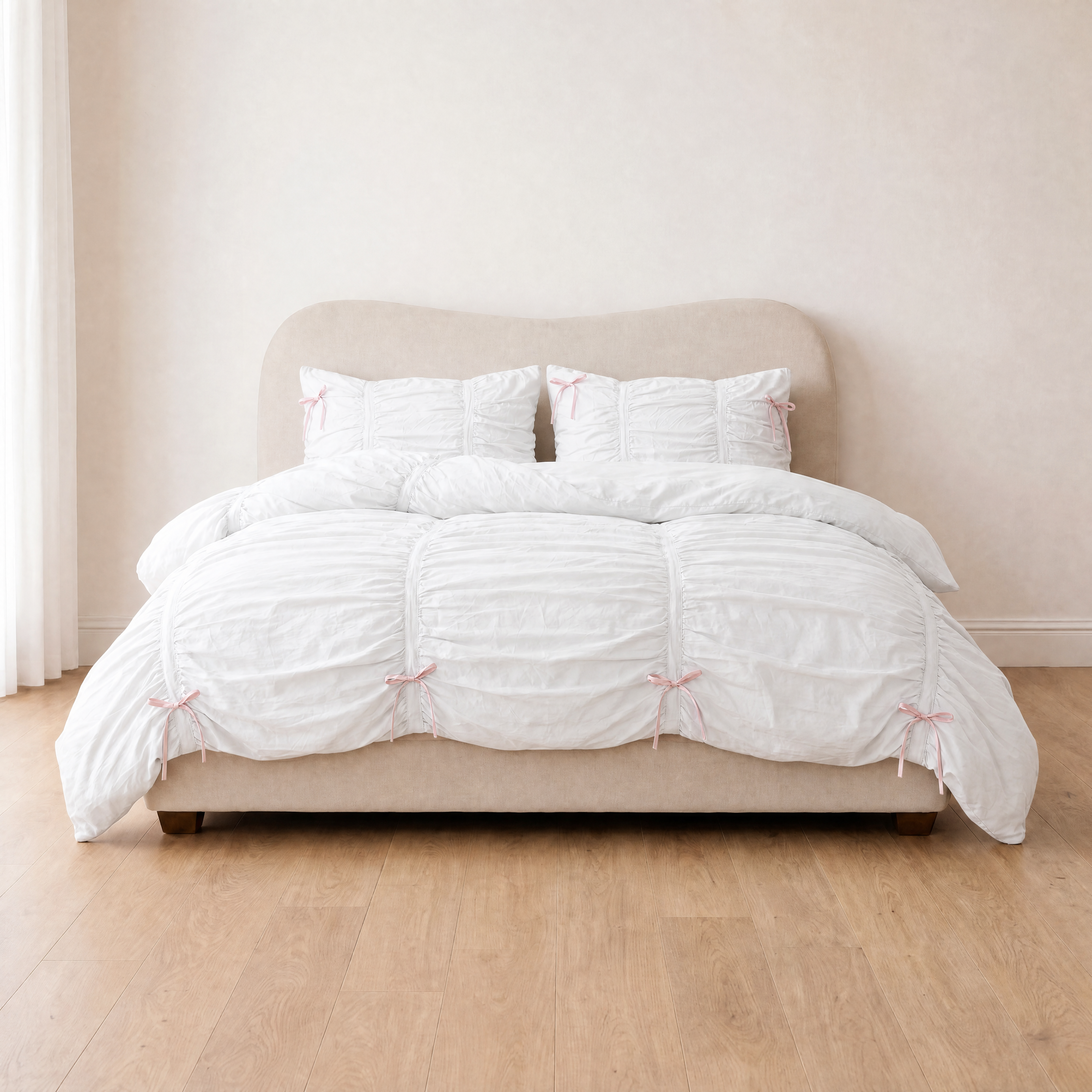 Metaya Bedding Set in Pink & White, ruched quilt cover with pink ribbon ties on a made bed
