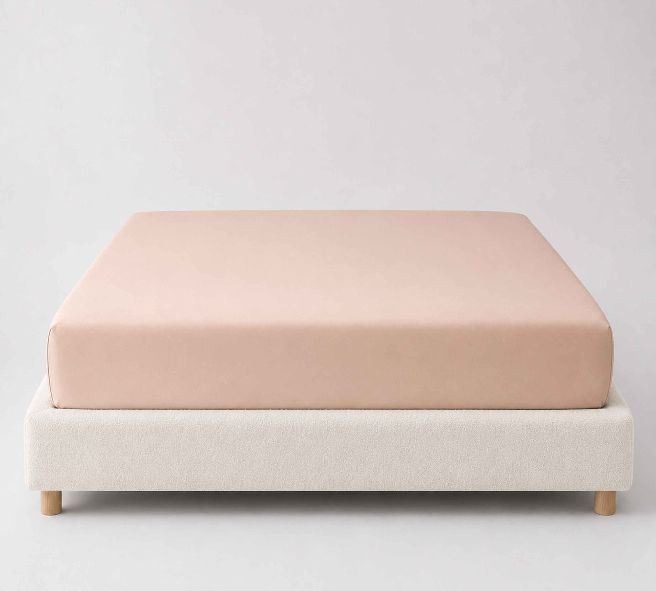 Mira Bamboo Fitted Sheet in Beige, fitted smoothly over a mattress on a boucle bed base