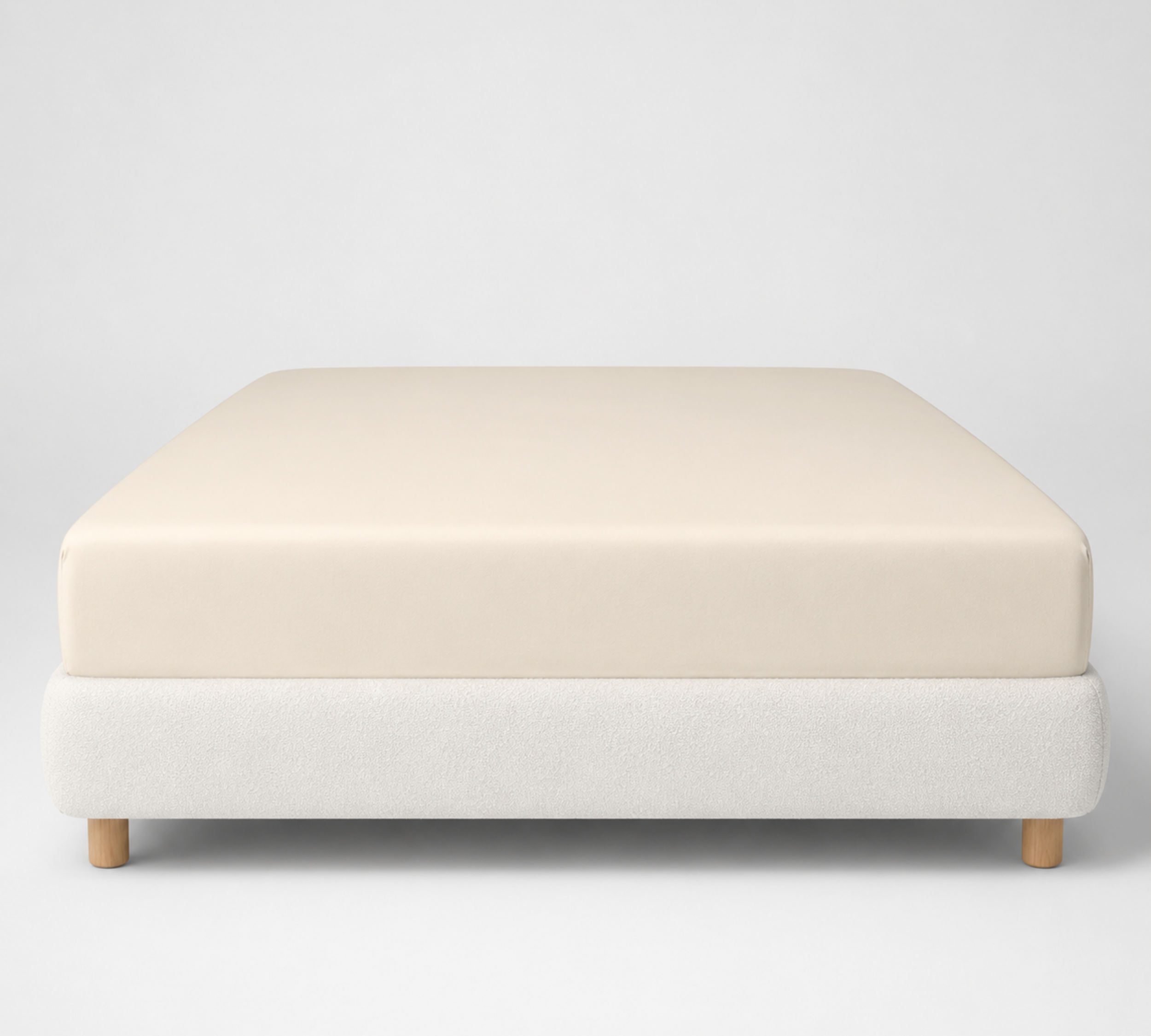 Mira Bamboo Fitted Sheet in Butter, smoothly fitted over a low platform bed base