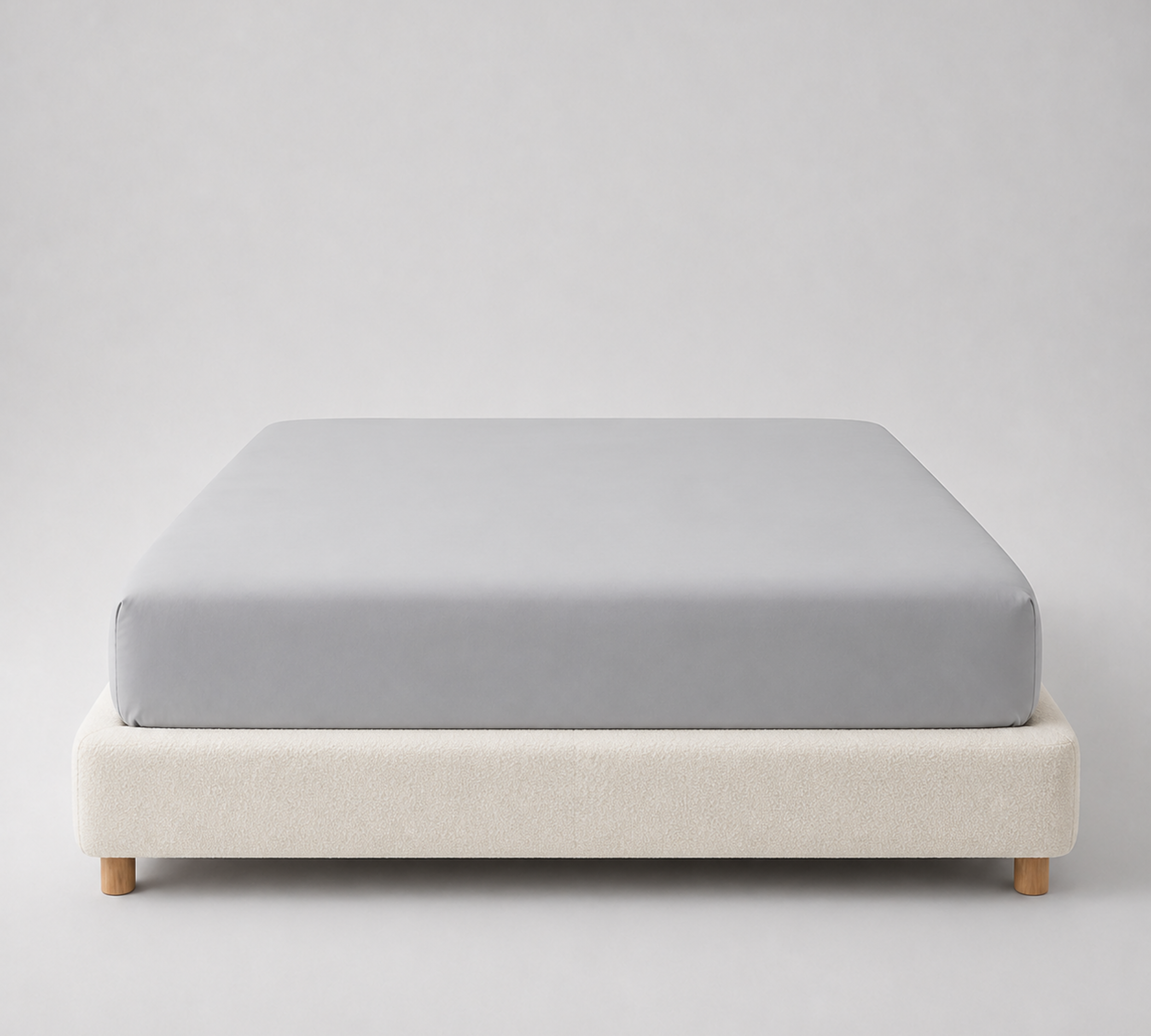 Mira Bamboo Fitted Sheet in Classic Grey, fitted smoothly over a mattress on a boucle bed base