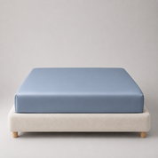 Mira Bamboo Fitted Sheet in Deep Blue, fitted snugly over a mattress with smooth bamboo sheen visible