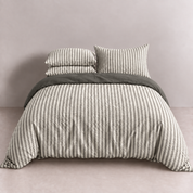 Noah Bedding Set in Ash, grey and white stripe quilt cover with matching pillowcases on a made bed