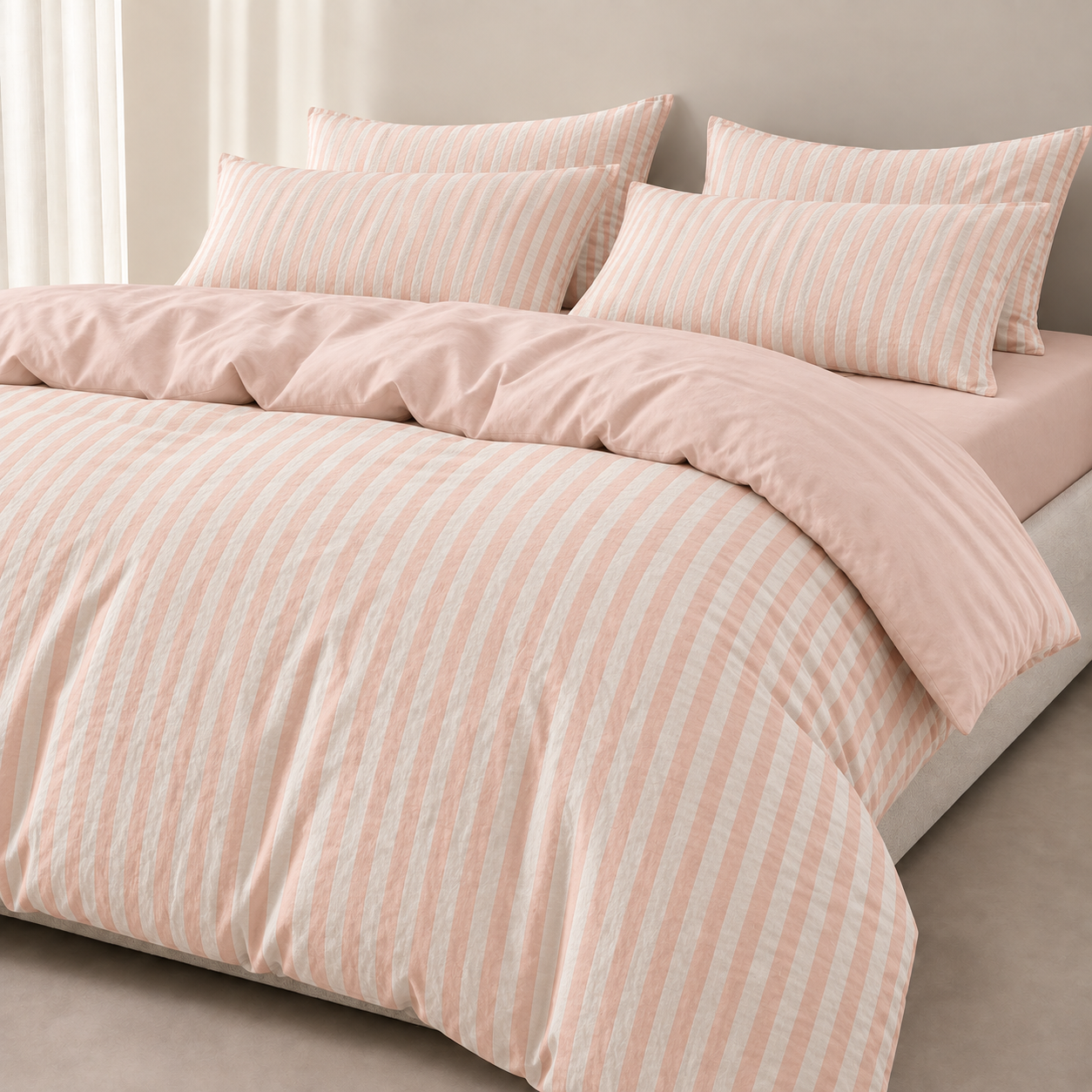 Noah Bedding Set in Blush, soft pink stripe quilt cover and pillowcases styled on a made bed