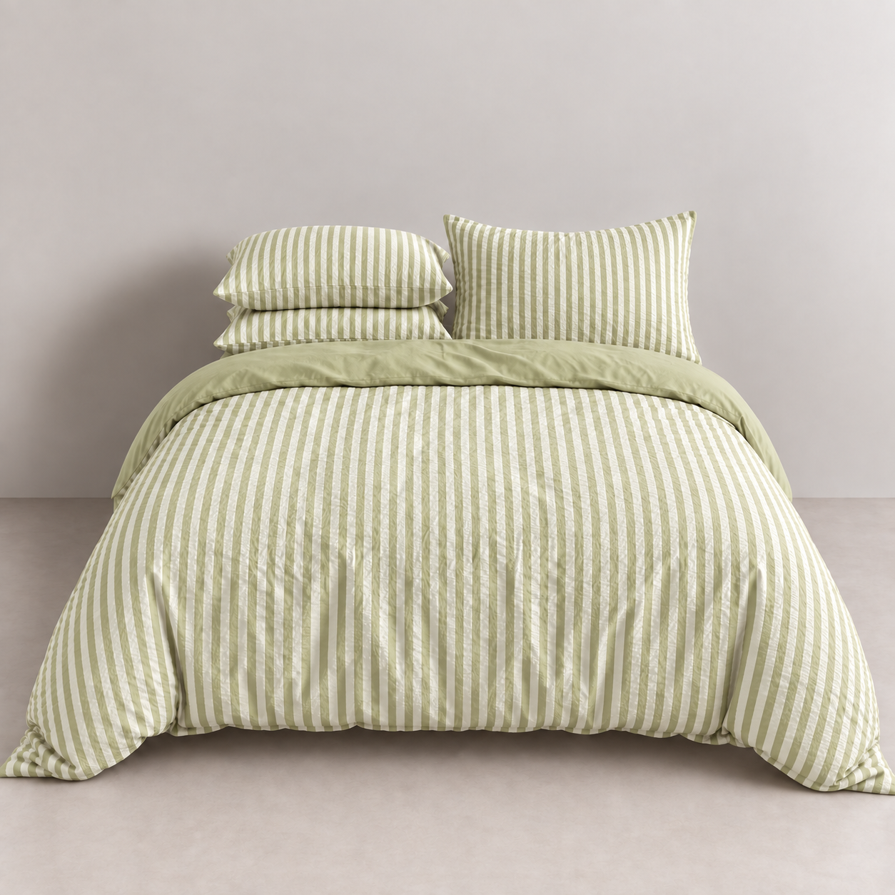 Noah Bedding Set in Lime, green striped quilt cover on a made bed with matching pillowcases