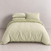 Noah Bedding Set in Lime, green striped quilt cover on a made bed with matching pillowcases
