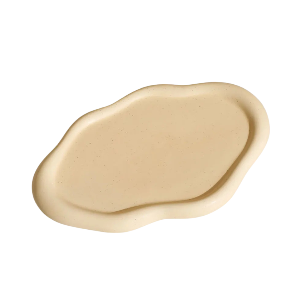 Nola Trinket Tray in Cream, cloud-shaped ceramic dish with a smooth speckled surface, shown on white