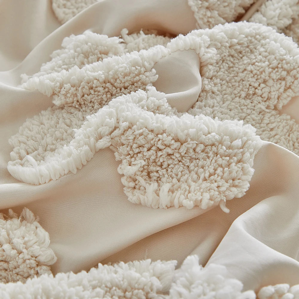 Close-up of tufted floral embroidery on the Posie Embroidered Bedding Set in creamy beige