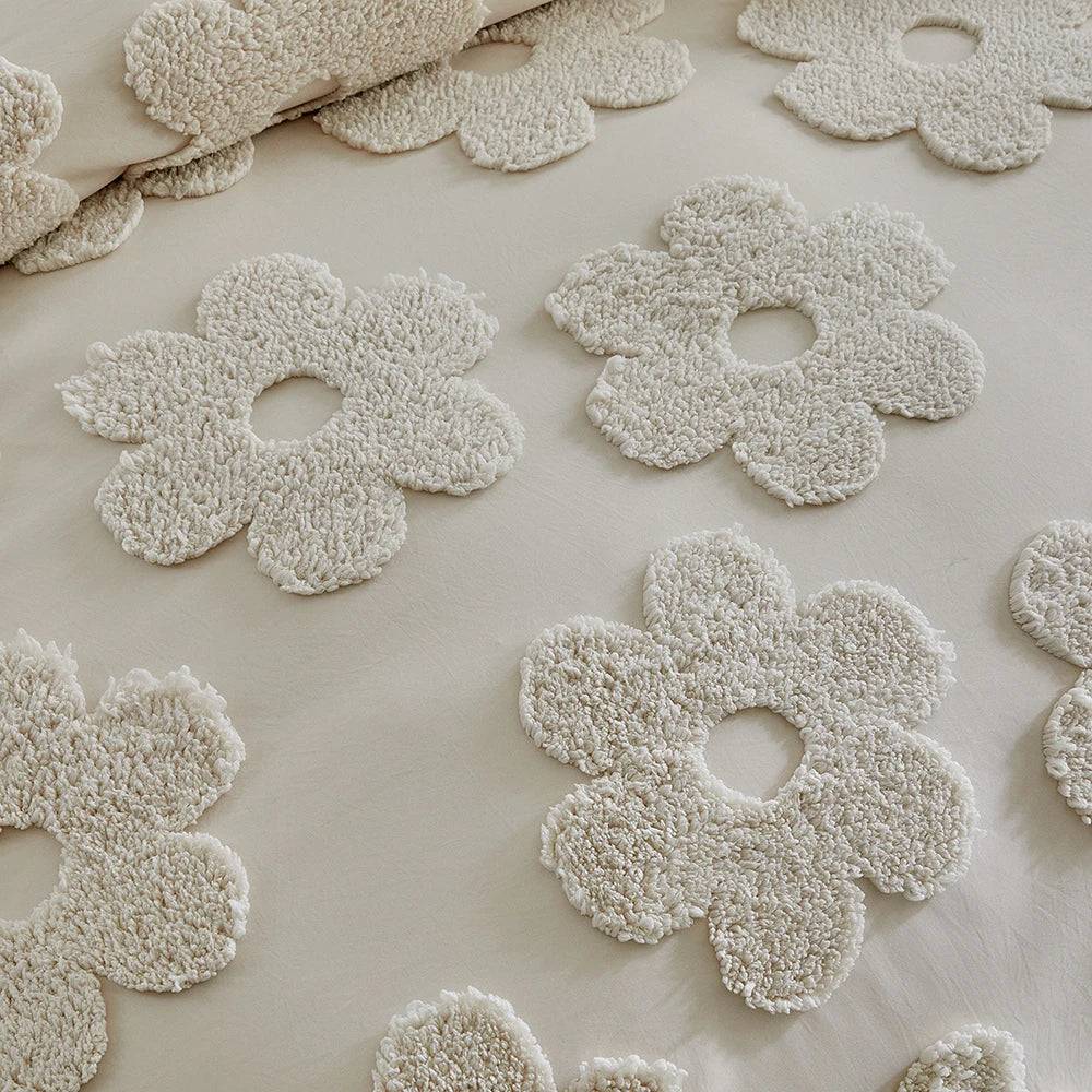 Close-up of tufted floral embroidery on the Posie Embroidered Bedding Set in creamy neutral cotton