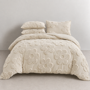 Posie Embroidered Bedding Set on a made bed, tufted cream floral blooms across quilt cover and pillowcases