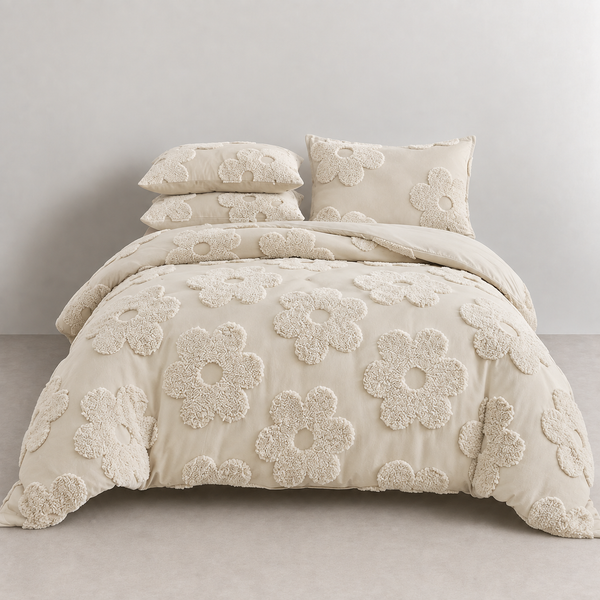 Posie Embroidered Bedding Set on a made bed, tufted cream floral blooms across quilt cover and pillowcases