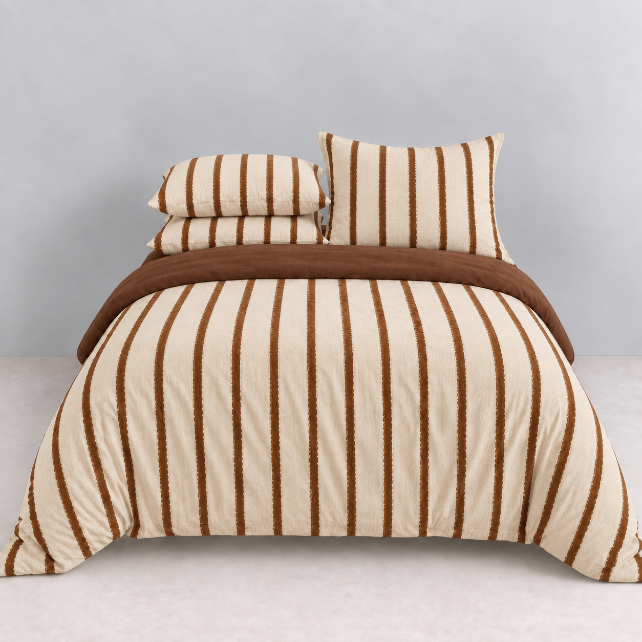 Rhodes Striped Bedding Set in Cocoa & Cream, made bed with cream quilt cover and brown vertical stripes