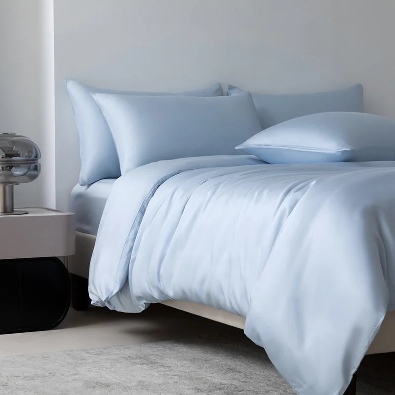 Soléa Bamboo Bedding Set in Blue Sky, sateen quilt cover draped with soft folds on a made bed