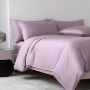 Soléa Bamboo Bedding Set in Charm Purple, sateen quilt cover and pillowcases styled on a made bed