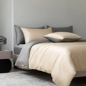 Soléa Bamboo Bedding Set in Cheese Yellow-Grey, sateen quilt cover and pillowcases on a made bed