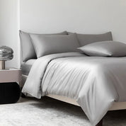 Soléa Bamboo Bedding Set in Classic Grey, sateen quilt cover and pillowcases styled on a made bed