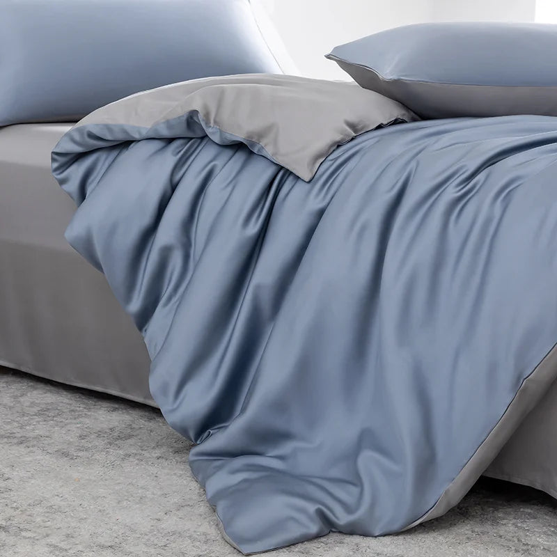 Soléa Bamboo Bedding Set in Deep Sea Blue - Grey, sateen quilt cover rumpled to show its reversible grey side