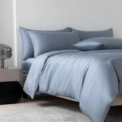 Soléa Bamboo Bedding Set in Deep Sea Blue, sateen quilt cover and pillowcases styled on a made bed