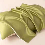 Close-up of a moss green pillowcase from the Soléa Bamboo Bedding Set, sateen fabric draped in soft folds
