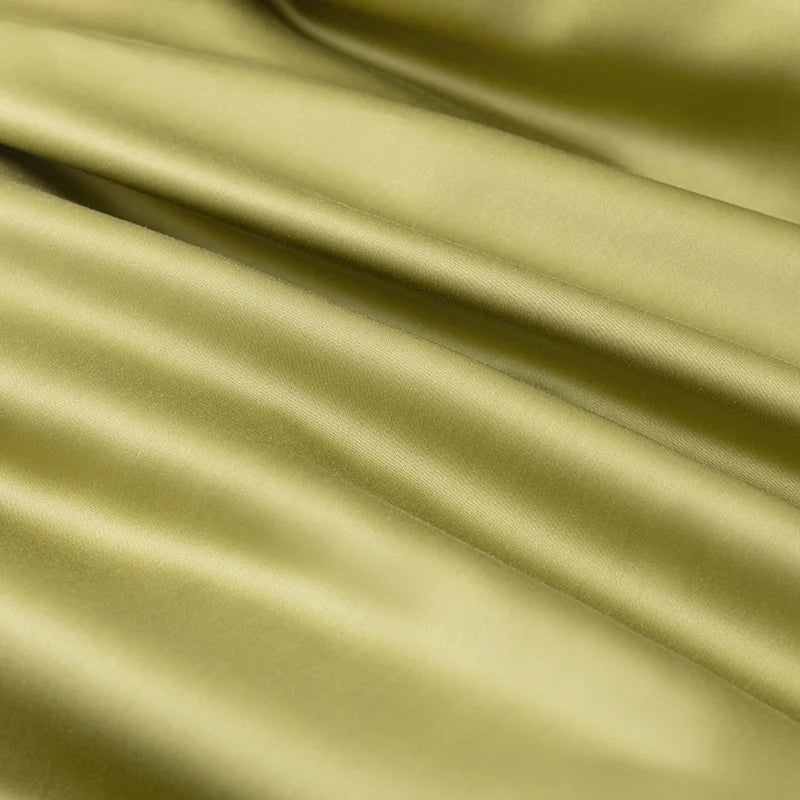 Close-up of the Soléa Bamboo Bedding Set in olive green, sateen weave with soft sheen and draped folds