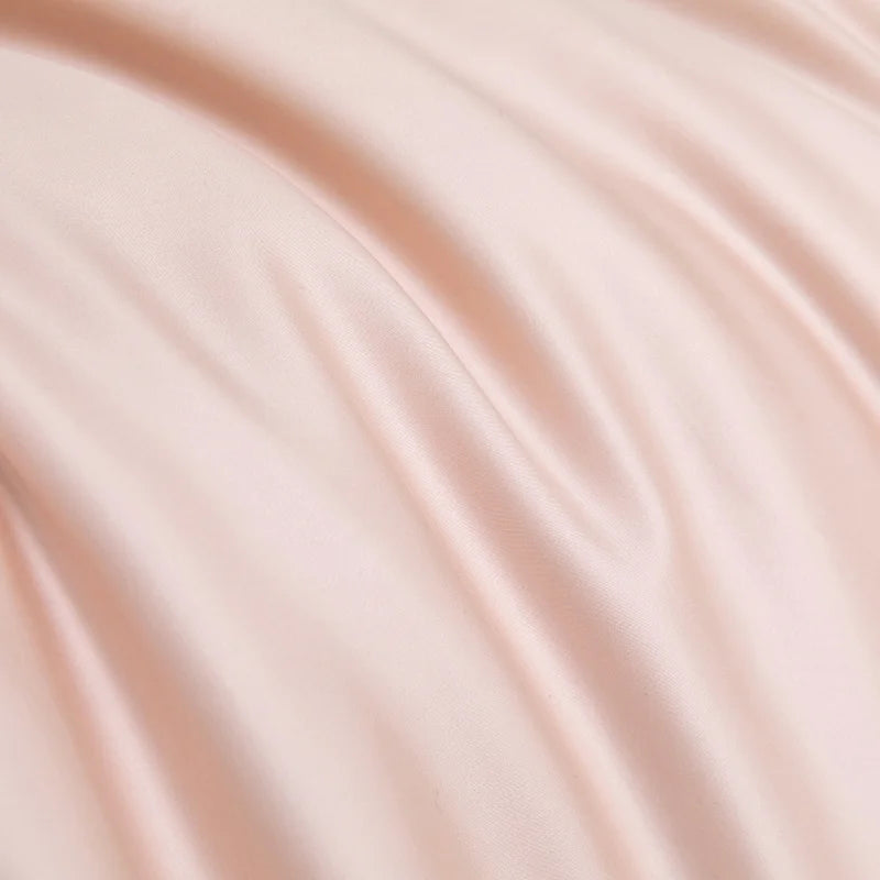 Close-up of the Soléa Bamboo Bedding Set in soft blush pink, showing its smooth sateen sheen and drape
