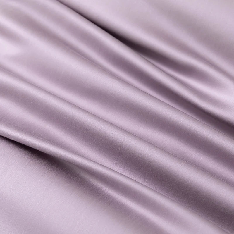 Close-up of the Soléa Bamboo Bedding Set fabric in dusty mauve, showing its smooth sateen sheen and drape
