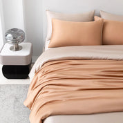 Soléa Bamboo Bedding Set in Rose Gold - Beige, sateen quilt cover draped with soft sheen on a made bed