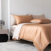 Soléa Bamboo Bedding Set in Rose Gold - Beige, sateen quilt cover and pillowcases on a made bed