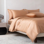 Soléa Bamboo Bedding Set in Rose Gold, sateen quilt cover and pillowcases styled on a made bed