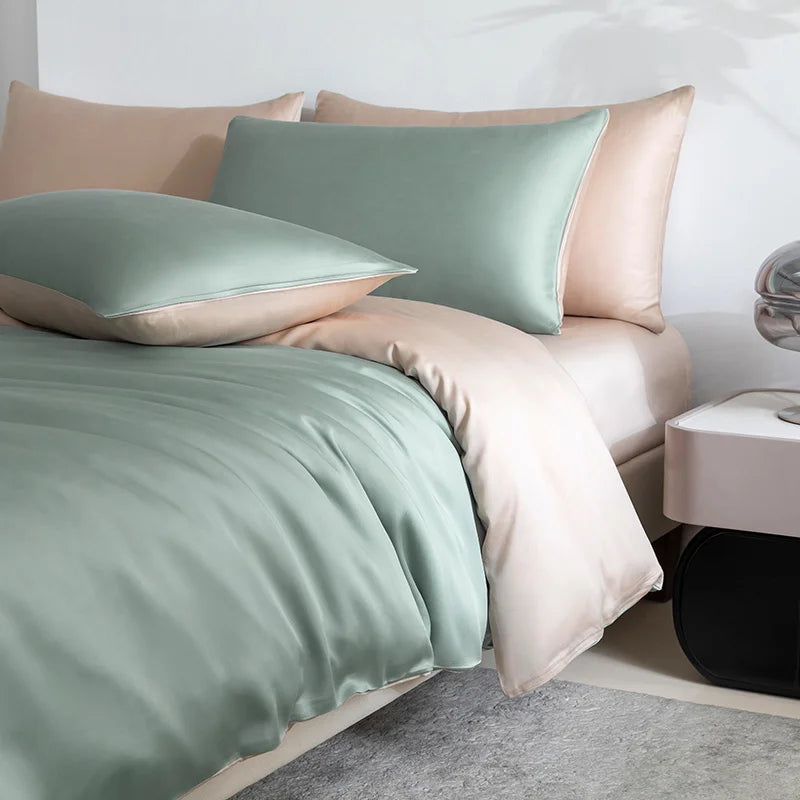 Soléa Bamboo Bedding Set styled on a bed, sage green quilt cover with beige reverse pillowcases