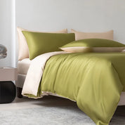 Soléa Bamboo Bedding Set styled on a bed, olive green quilt cover with beige reverse and pillowcases